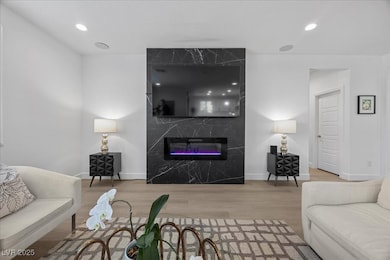 Living area with wood finished floors, baseboards,