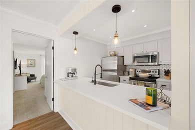 Kitchen featuring ornamental molding, a peninsula,