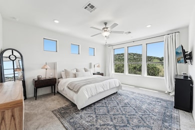 Bedroom with baseboards, carpet, visible vents, a