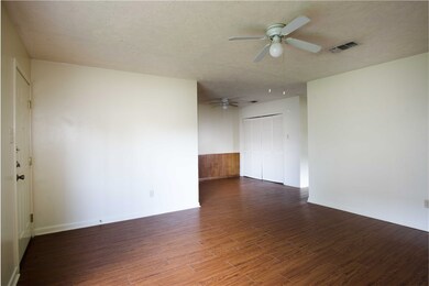 Unfurnished room with ceiling fan, a textured ceil