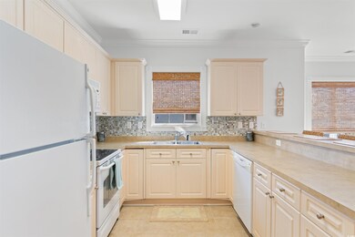 Kitchen with decorative backsplash, white applianc