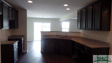 View of the kitchen from the dining room.  The kit