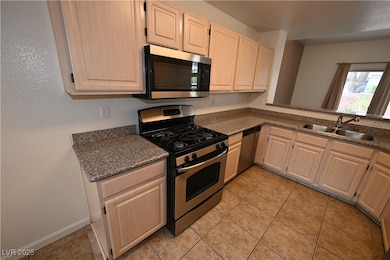 Kitchen featuring stainless steel appliances, a si