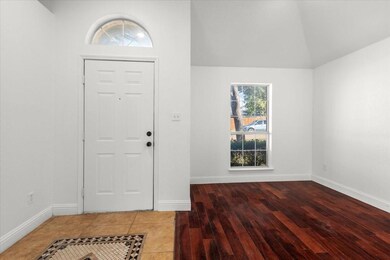 Foyer with hardwood / wood-style flooring and loft