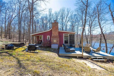 View of side of property featuring a wooden deck,