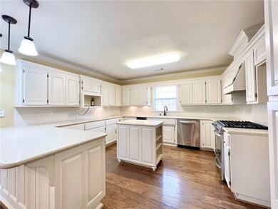 Large kitchen with island, solid surface counterto