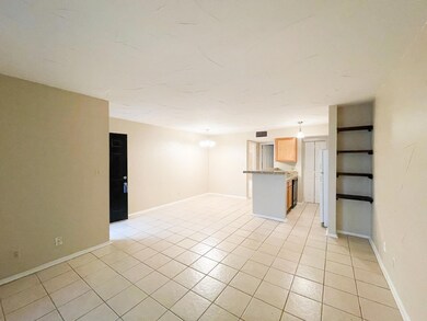 Unfurnished living room featuring light tile patt