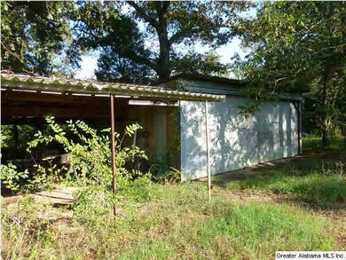 Large metal building in the back of the property