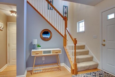 Entry way into the home with hardwood floors and f