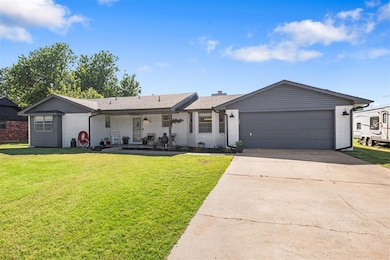 Single story home with brick siding, concrete driveway, a front yard, and an attached garage