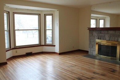Gas log fireplace with stone hearth