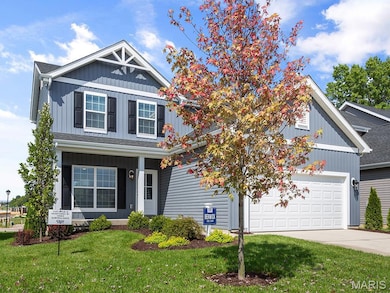 Craftsman inspired home with a front yard