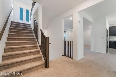 Staircase featuring carpet flooring and baseboards