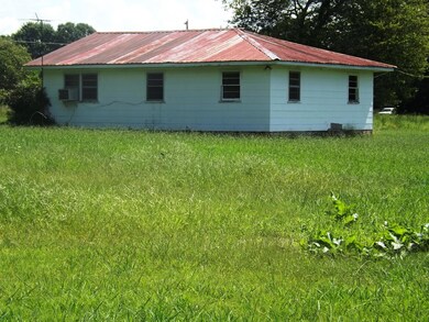 This is a side view of the house. With a few repairs, this home would be a great rental or first time home.