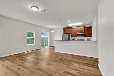 Kitchen with stainless steel appliances, baseboar