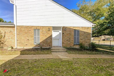 Doorway to property with a yard