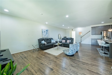 Living area featuring stairs, dark wood finished f