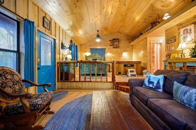 Living room featuring ceiling fan, light hardwood 