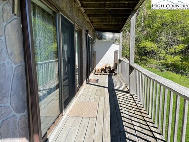 Back deck with two sliding doors leading in the gr