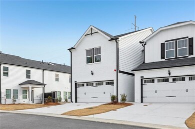 View of front of home with a garage, brick siding,