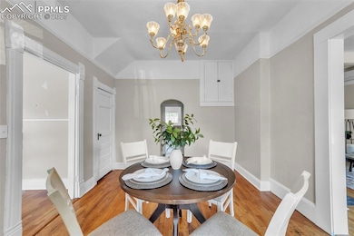 Dining room featuring original wood flooring and a chandelier