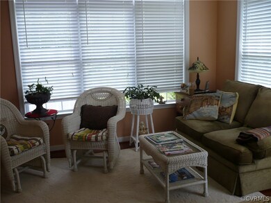 Sunroom with ceiling fan, hardwood flooring