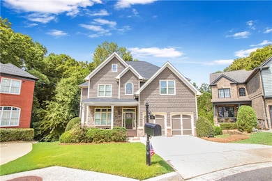 View of front of home featuring concrete driveway, a front yard, an attached garage, a porch, and stone siding