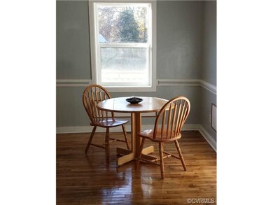 Dining area with original refinished hardwood floo