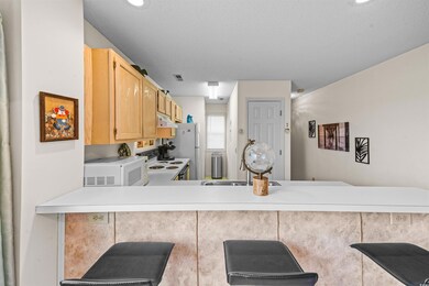 Kitchen with kitchen peninsula, a textured ceiling