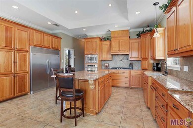 Abundance of custom cabinetry for storage is accen