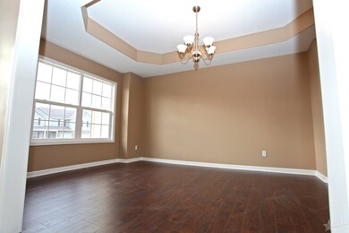 Tray ceiling and wood floors in the dining room wi