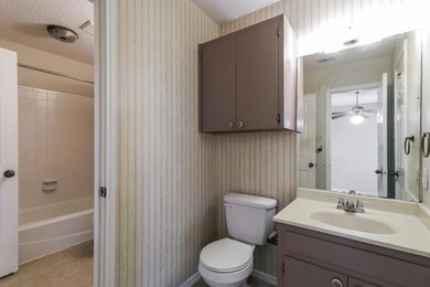 Full bath with vanity, tile patterned flooring, s