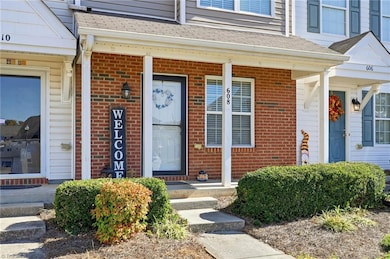 Front with brick & covered front porch