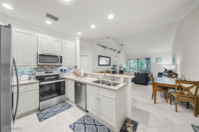 Kitchen featuring visible vents, a sink, appliance