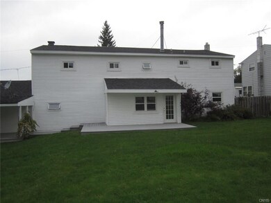 Back of home with view of deck