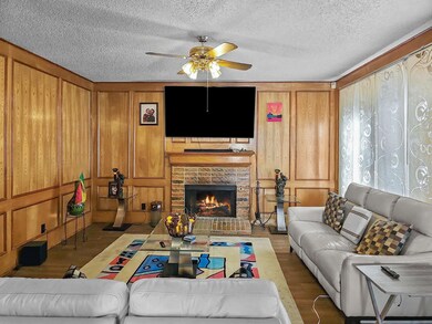 Living room featuring ceiling fan, hardwood / wood