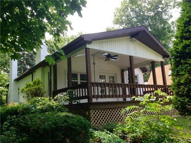 Covered rear porch of main residence sits under 4 