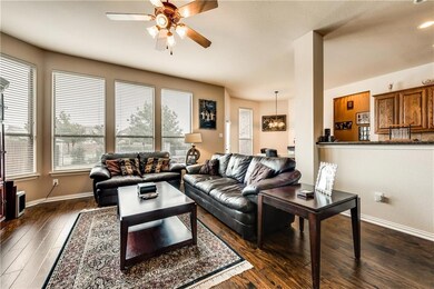 The sunny living room features beautiful wood floo