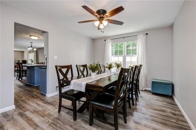 Spacious dining room right off the kitchen with beautiful views of the wooded backyard.