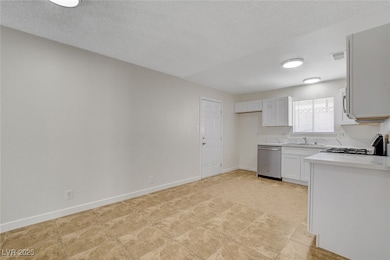 Kitchen featuring stainless steel dishwasher, a si