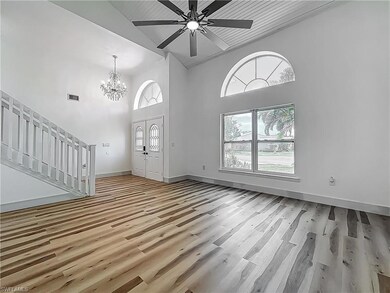 Foyer entrance with high vaulted ceiling, a wealth