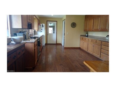 Kitchen looking toward enclosed rear porch and gar