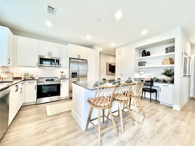 Kitchen featuring a kitchen bar, a center island, 