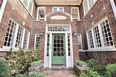 Entrance to property featuring brick siding
