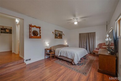 Bedroom with wood finished floors and a ceiling fan