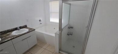 Full bath featuring a stall shower, a garden tub,