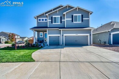Great curb appeal with lush green grass, shrubs, a