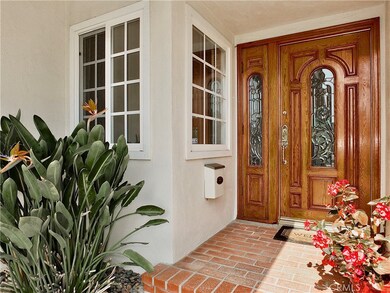 Brick porch with solid wood door and opening side light to catch the ocean breezes.