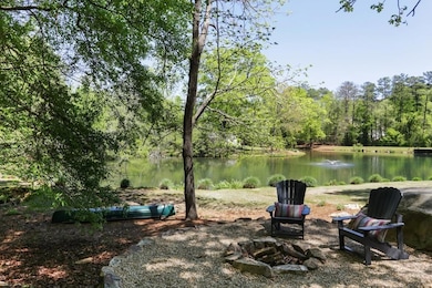 View of yard with a fire pit, a water view, and a wooded view