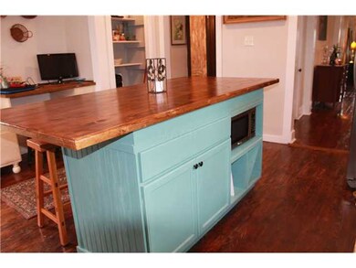 Island in kitchen adds extra storage and counter s